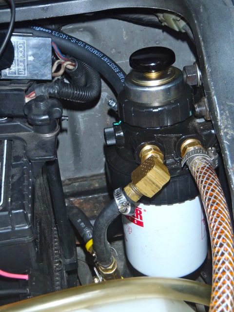temporary plastic wvo line, replaced with fuel line, in from the back. the three way manual ball valve is at bottom center, but cant really see it
