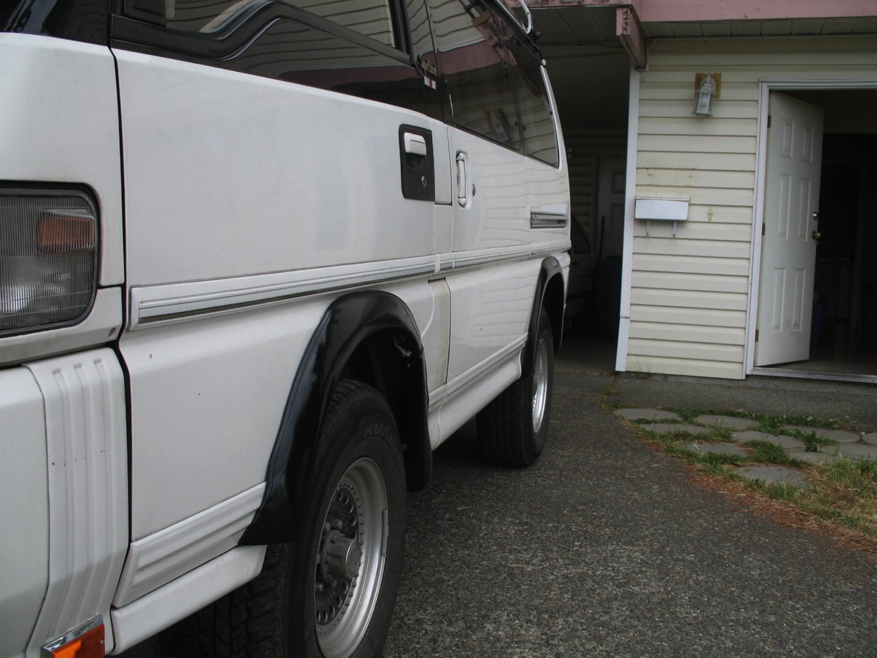 The fender flares - side door clears it fine.
