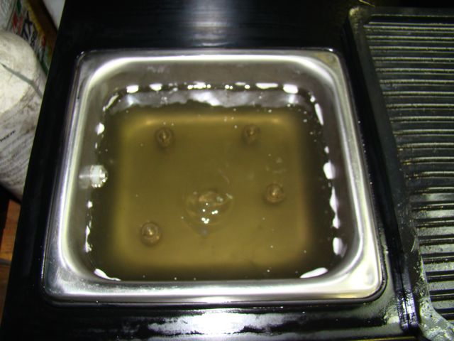 Injectors being ultrasonically reamed, steamed, and drycleaned.