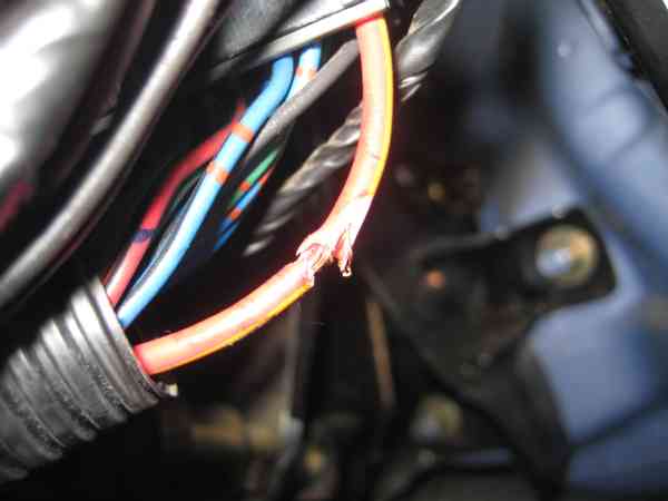 This was how the original wire was spliced into.  Notice that the insulation is torn, and that some of the strands of the wire are broken.