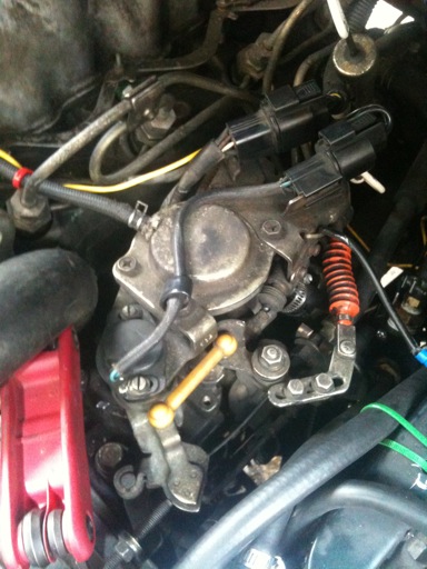 The leak is coming from the sides of this. The allen key (with the red handle) is in one of the screws where the top of the pump attaches to the lower part. This is the where the gasket is leaking.
