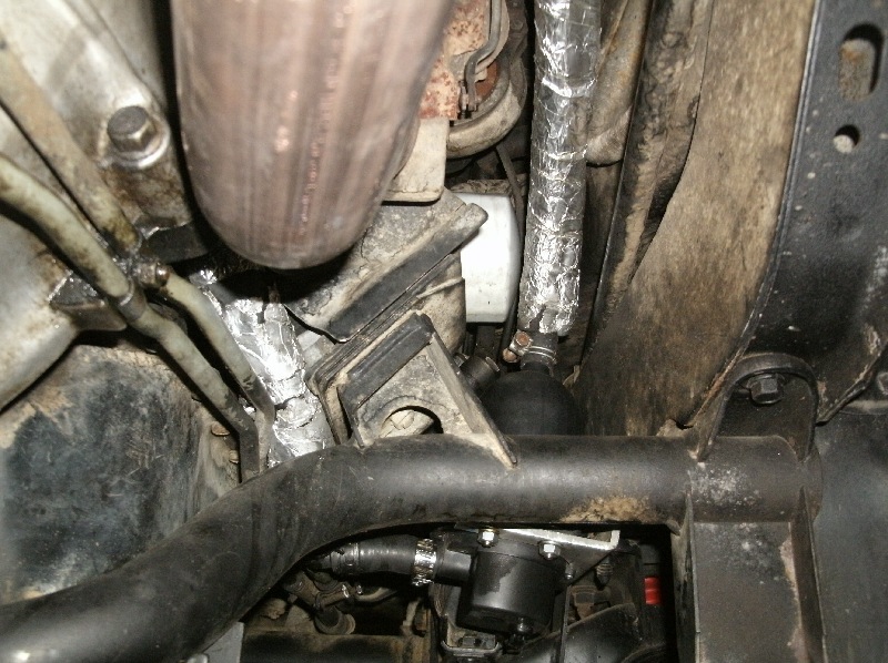 Hard to see, but this is looking forward from behind the trans towards the driver.  Looks tight, and indeed it is, but removal of the oil filter is possible without undoing the heater bracket.  Looks close to the manifold but has plenty of clearance...not even warm from driving.
