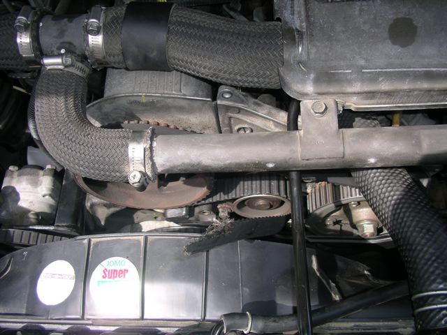Exposed balance belt - tensioner let go. Note the jagged, angled tear line.