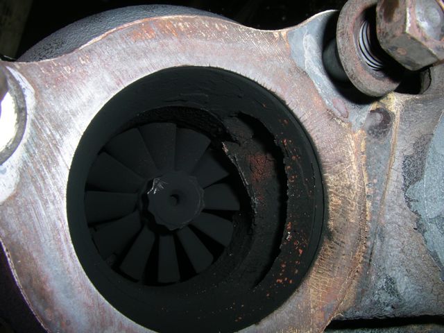 Inside turbo, hot side, note that the iron is coming apart and is a little short of obstructing the wheel